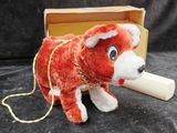 a stuffed animal that is sitting in front of a box