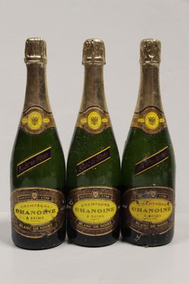 three bottles of champagne sitting on top of a white table