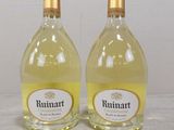 two bottles of wine sitting on top of a table next to each other