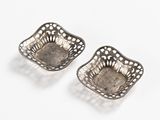 pair of antique silver plated dishes on a white background