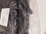 a bag of black plastic material sitting on a table