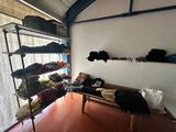 a room with a bench and shelves filled with clothes