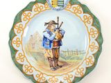 a plate with a picture of a man and a dog on it