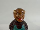 a figurine of a man with a big smile on his face
