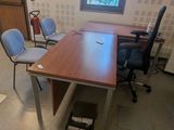 une photo d'un bureau vide avec un bureau et des chaises