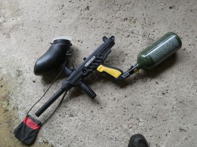 a paintball gun and a paintball gun on the ground