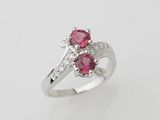 a white gold ring with two pink sapphires and diamonds