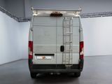 a white van with a ladder on the back of it