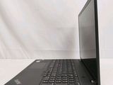 the back of a laptop computer sitting on top of a white table
