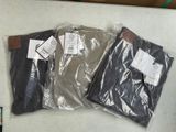 trois paires de pantalons pour homme posées sur une table