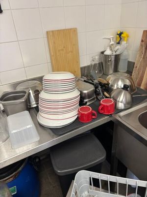 many plates and cups on the counter in the kitchen