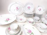 a lot of plates and cups and saucers on the table