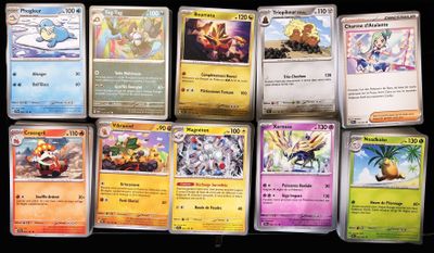 several pokemon cards are lined up on a black surface