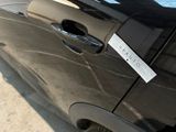 a black car with a sticker on the side of it ' s door