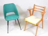 two chairs sitting next to each other on a white surface