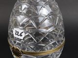 a close up of a glass egg box on a black surface