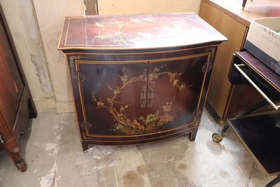 a small cabinet with a floral design on it