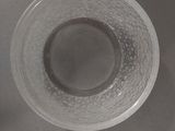 a glass of water sitting on a sink next to a faucet