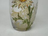 a glass vase with a flower painted on it