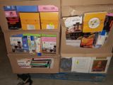 many boxes of books on a pallet in a room