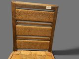 a wooden chair with a woven seat on a gray background