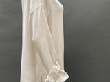 the mannequin is wearing a white top and white pants