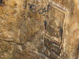a close up of a statue of a building on a rock