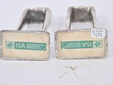 pair of silver cufflinks with a green and white label on them