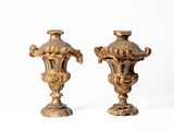 deux vases en or posés l'un à côté de l'autre sur une surface blanche
