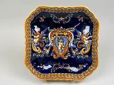 a blue and gold plate with a picture of a woman on it