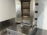 stainless steel counter top with a large open oven on top of it