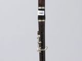 a close up of a clarinet on a clear surface with a white background