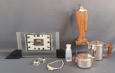 a silver clock, a silver teapot, a silver teapot, a silver teapot, a silver teapot, a silver teapot and a