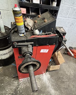 a machine that is sitting on the ground next to a trash can