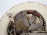 a white helmet with a brown band around the brim