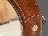 a close up of a mirror with a wooden frame