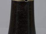a close up of a black vase with a gold rim
