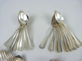 silver spoons and spoon spoons on a white plate