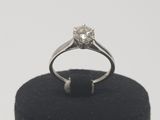 an image of a diamond ring sitting on a black ring holder