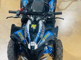 an image of a blue and black four wheeler atv