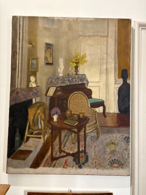 a painting on the wall of a room with a chair and table