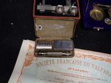 a small box with a razor in it sitting on a table