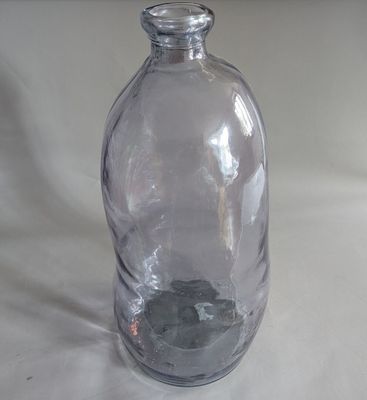 a clear glass bottle with a rock inside of it