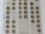a lot of coins in a plastic bag on a table
