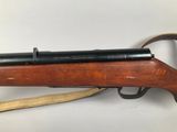 a rifle with a wooden barrel and a wooden handle