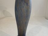 a blue vase that is sitting on a white surface