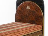 a bed with a wooden headboard and a striped blanket