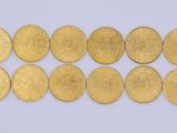 a close up of a row of gold coins on a white surface