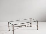 a glass coffee table with metal legs and a glass top