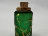 an image of a green glass bottle with a gold lid